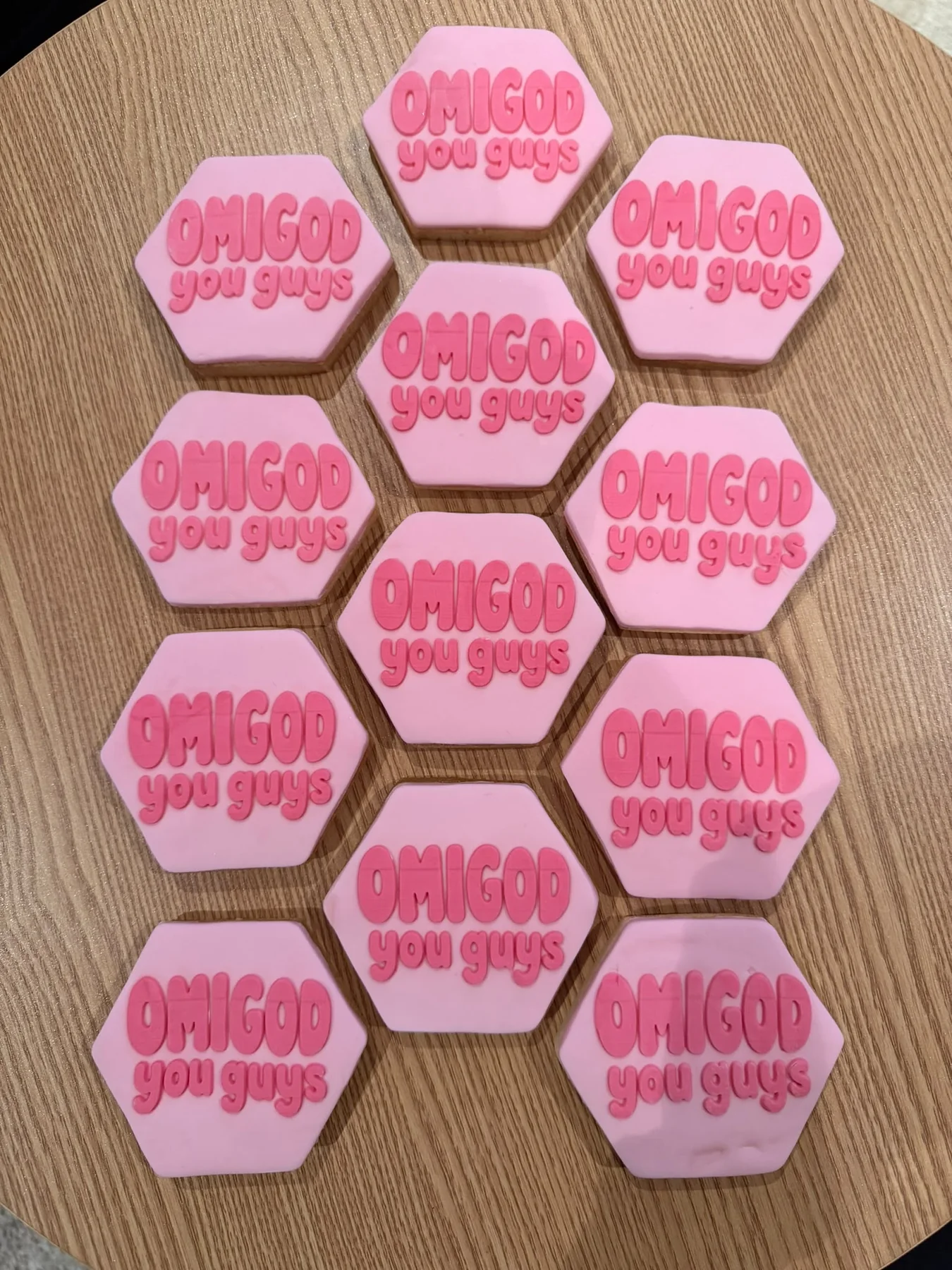 Pink hexagonal iced cookies with a playful OMGOD message.