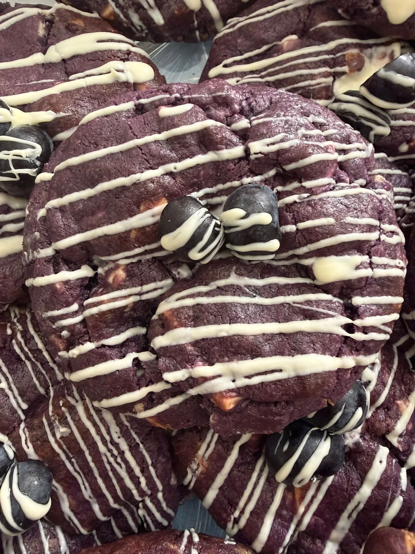 Red velvet cookies drizzled with white chocolate.
